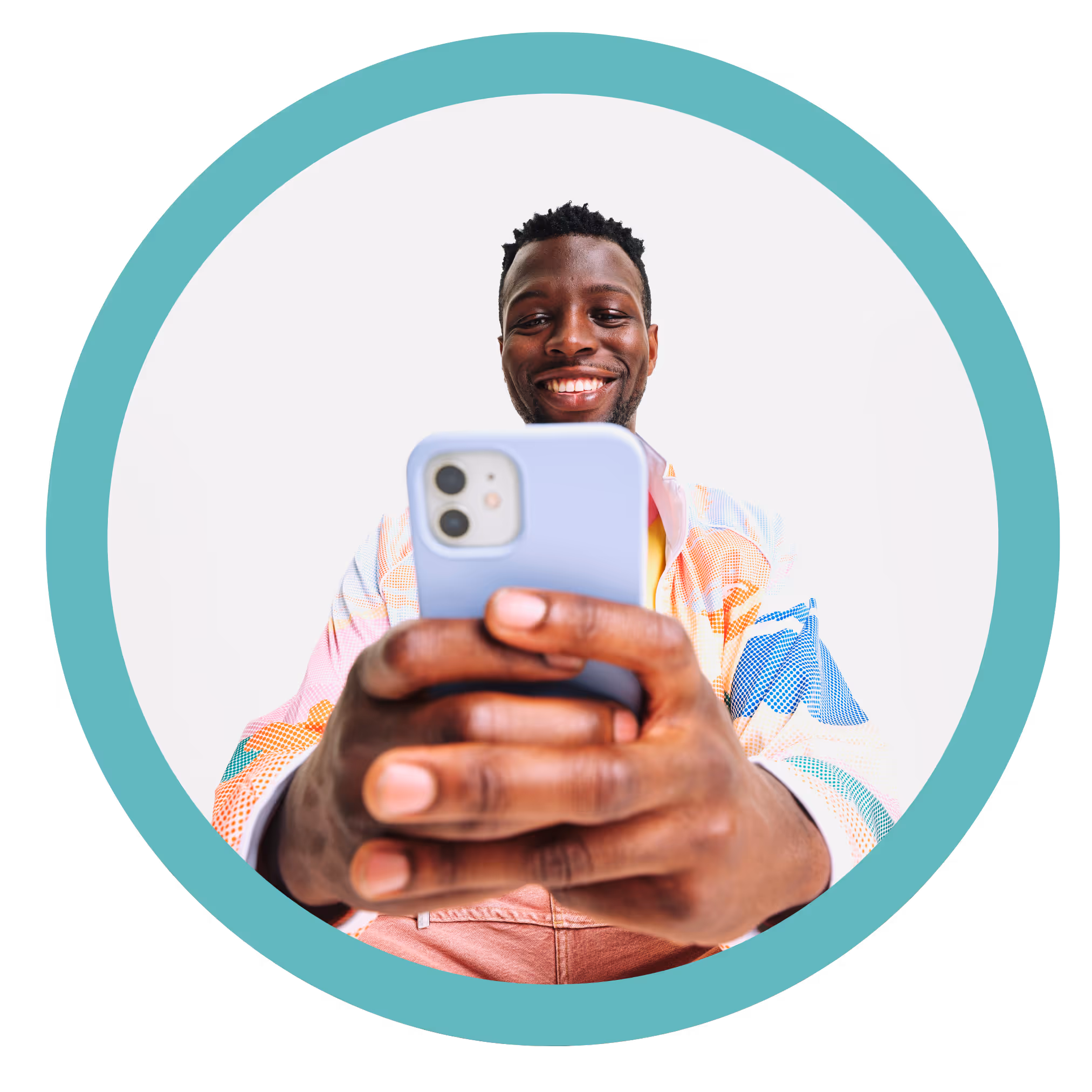 Smiling man with multicolored jacket holding a phone with lavender case, looking at the screen.