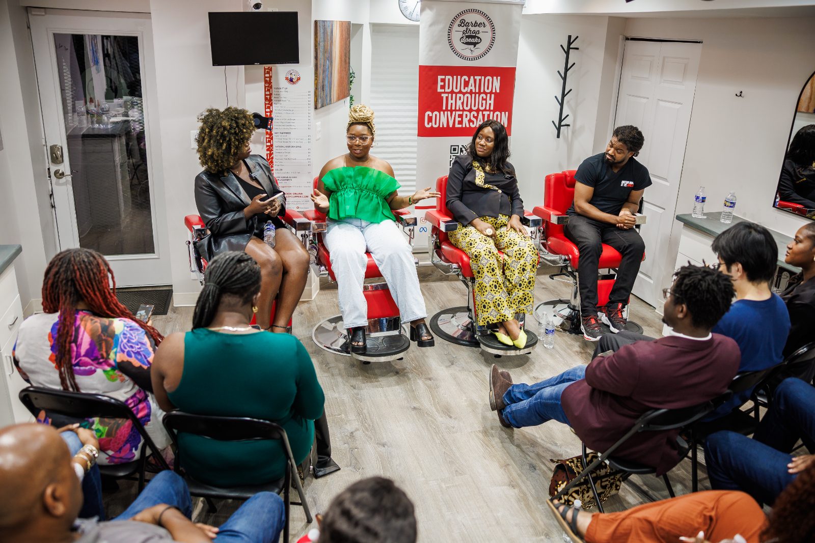 Panel discussion at a Kredit Academy financial wellness activation in a barbershop