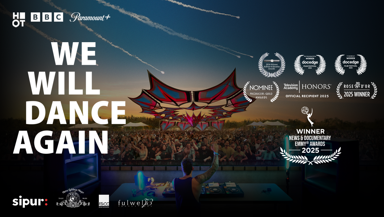 a DJ performing on a festival stage