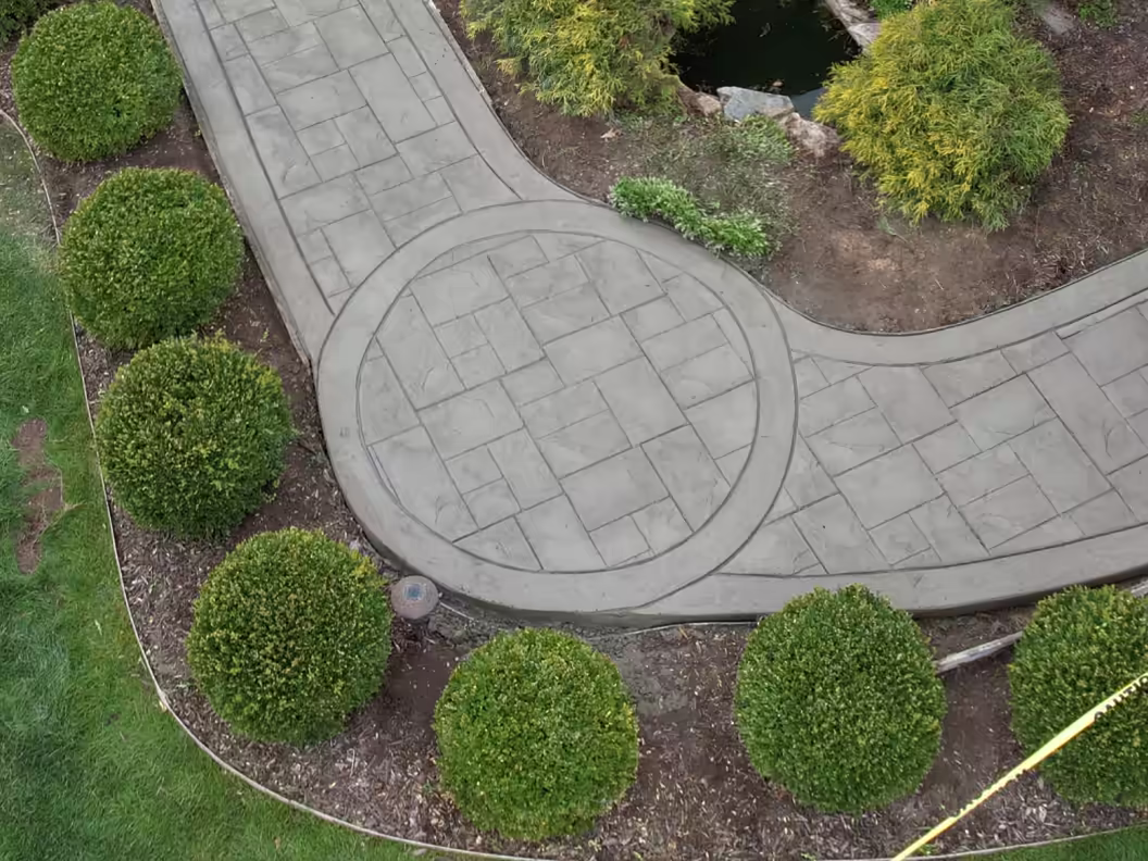 Aerial view of curved stamped concrete walkway with circular medallion detail, Grand Rapids MI