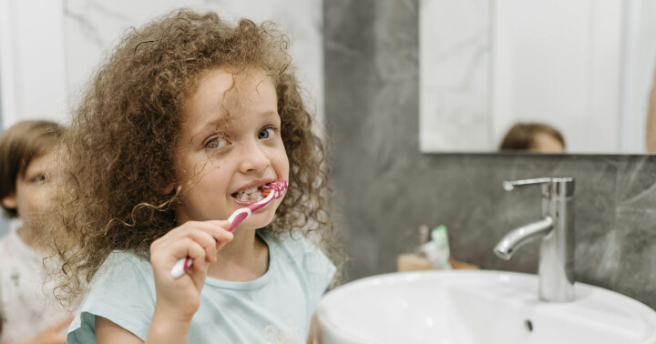 A child brushing their teeth
