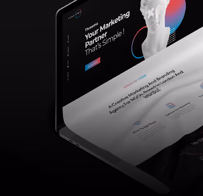 A laptop displaying a colorful website design on its screen, showcasing various layout elements and graphics.