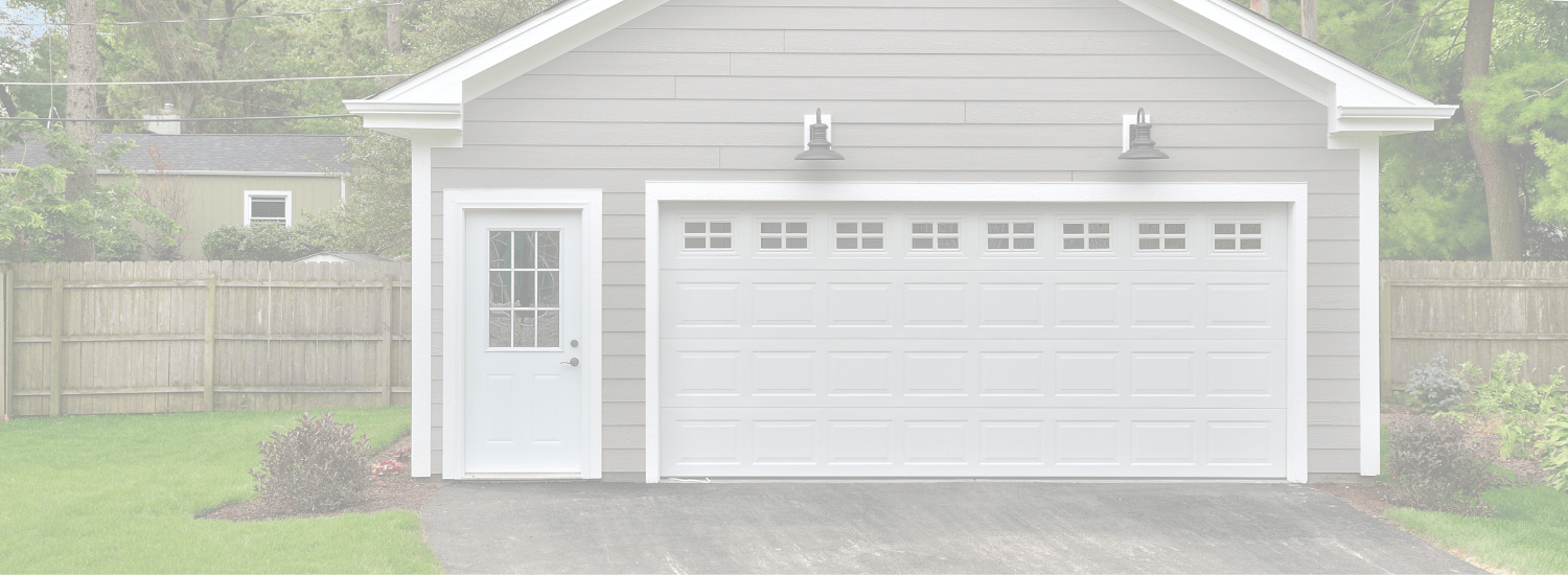 Gray detached garage with white door and side entry — a common candidate for a garage conversion in the Seattle area.