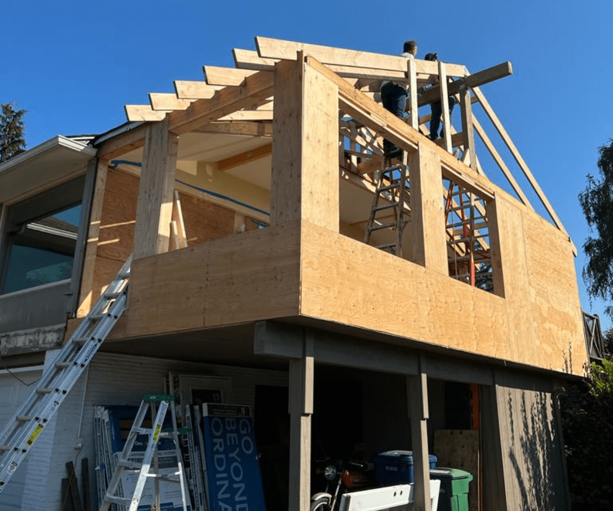 General contractor crew framing a home addition in the Seattle area — a GC coordinates every trade on the job.