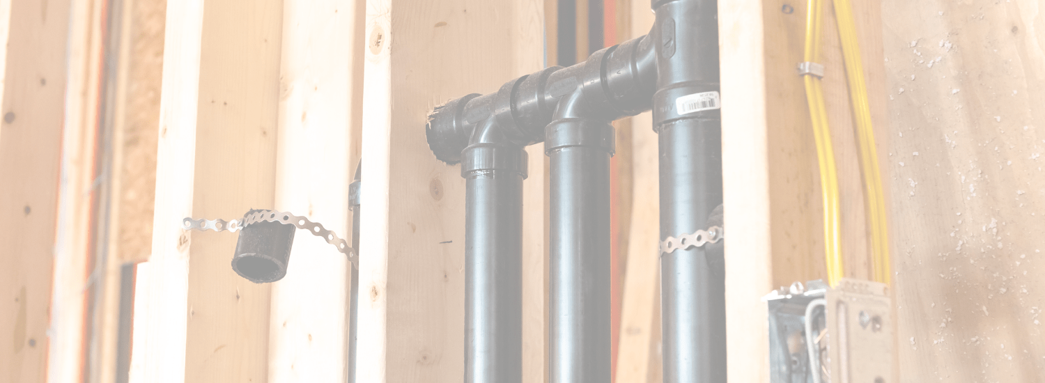 Open wall framing with new electrical wiring and plumbing during a Seattle remodel — the right time to add an EV charger circuit.