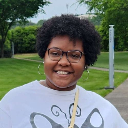 Our team member, Mekayla, against a grassy background