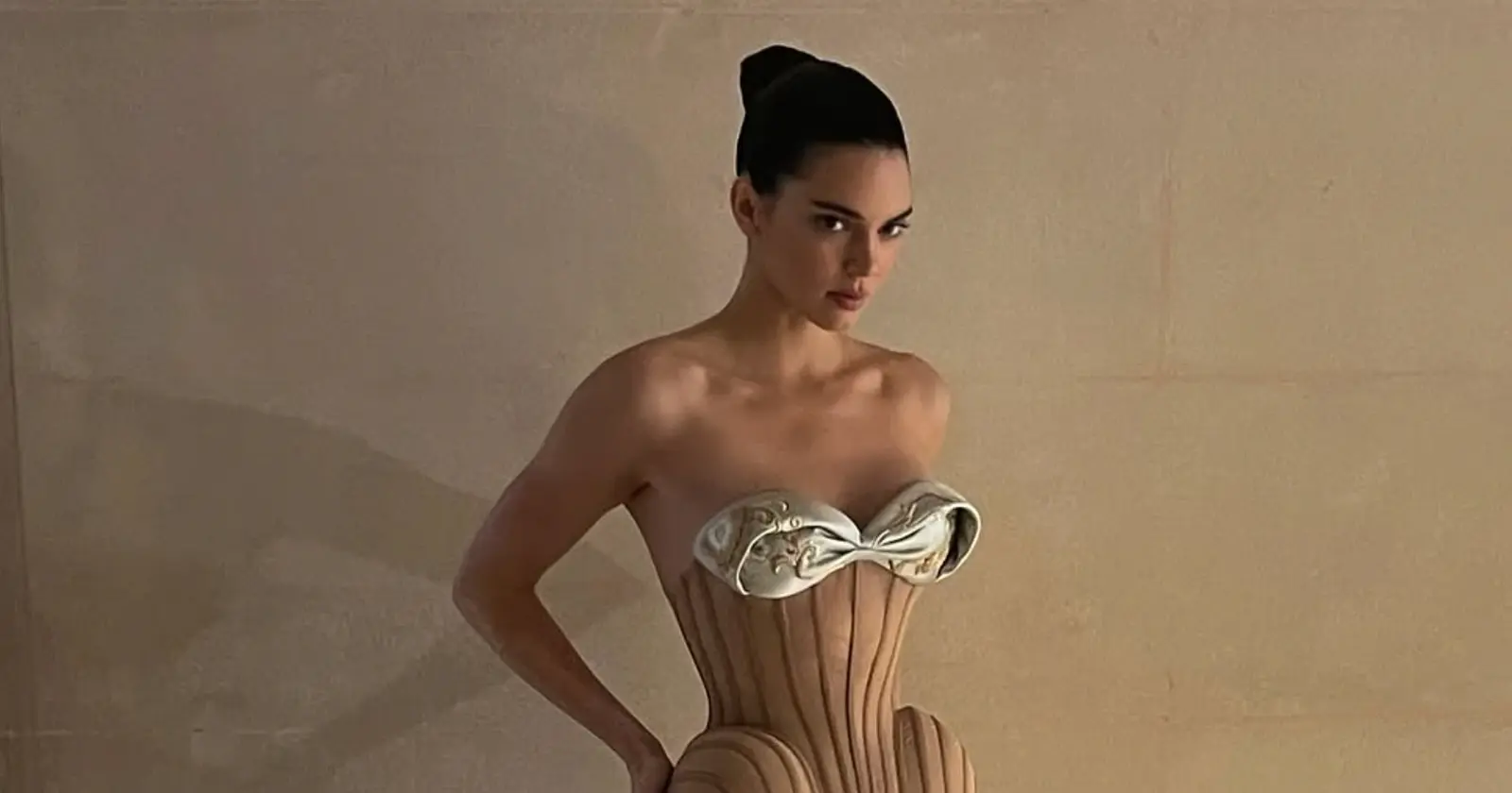 Kendall Jenner poses in a sculptural strapless designer gown with metallic details in a fashion shoot.