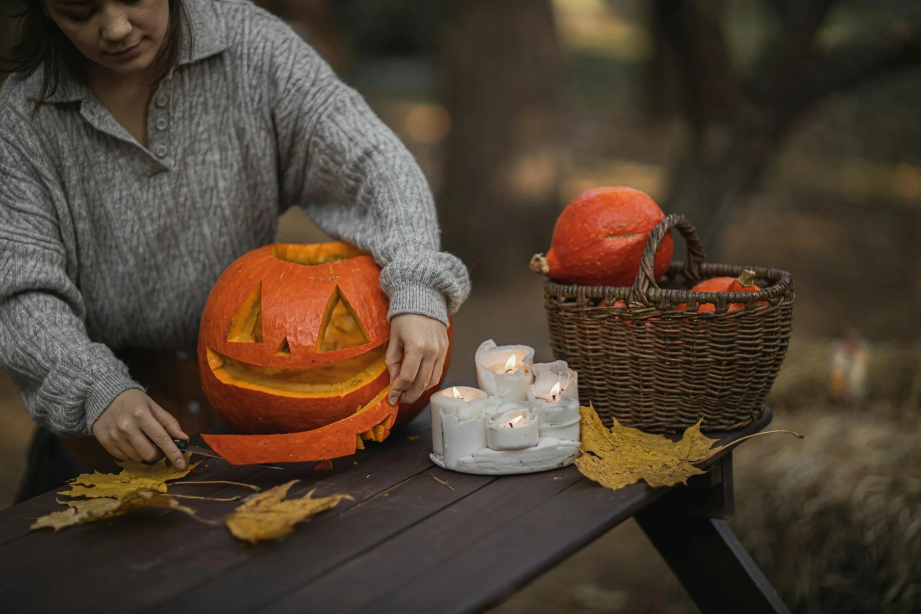 woman with carved pumpkins