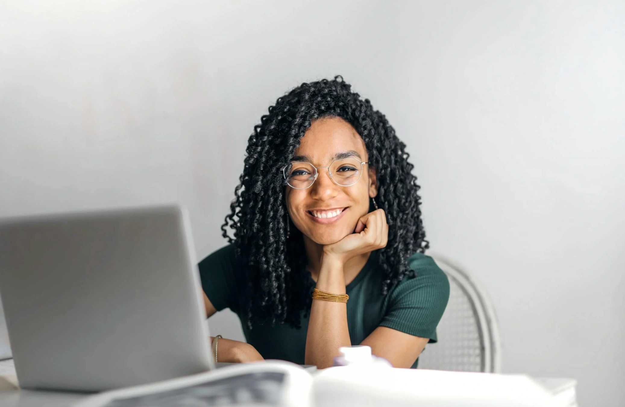 happy woman behind laptop