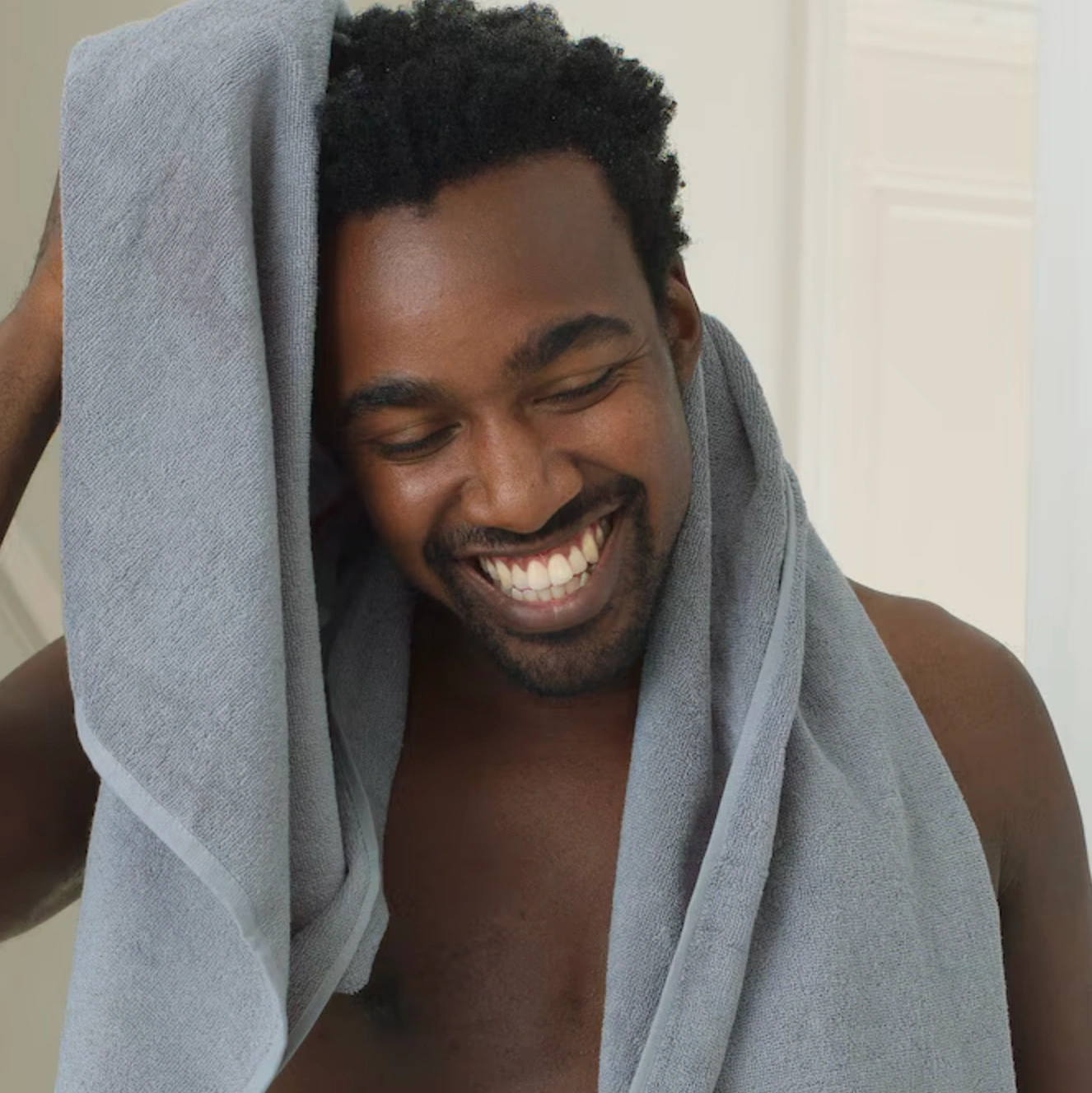 Dove imagery, man drying hair with towel