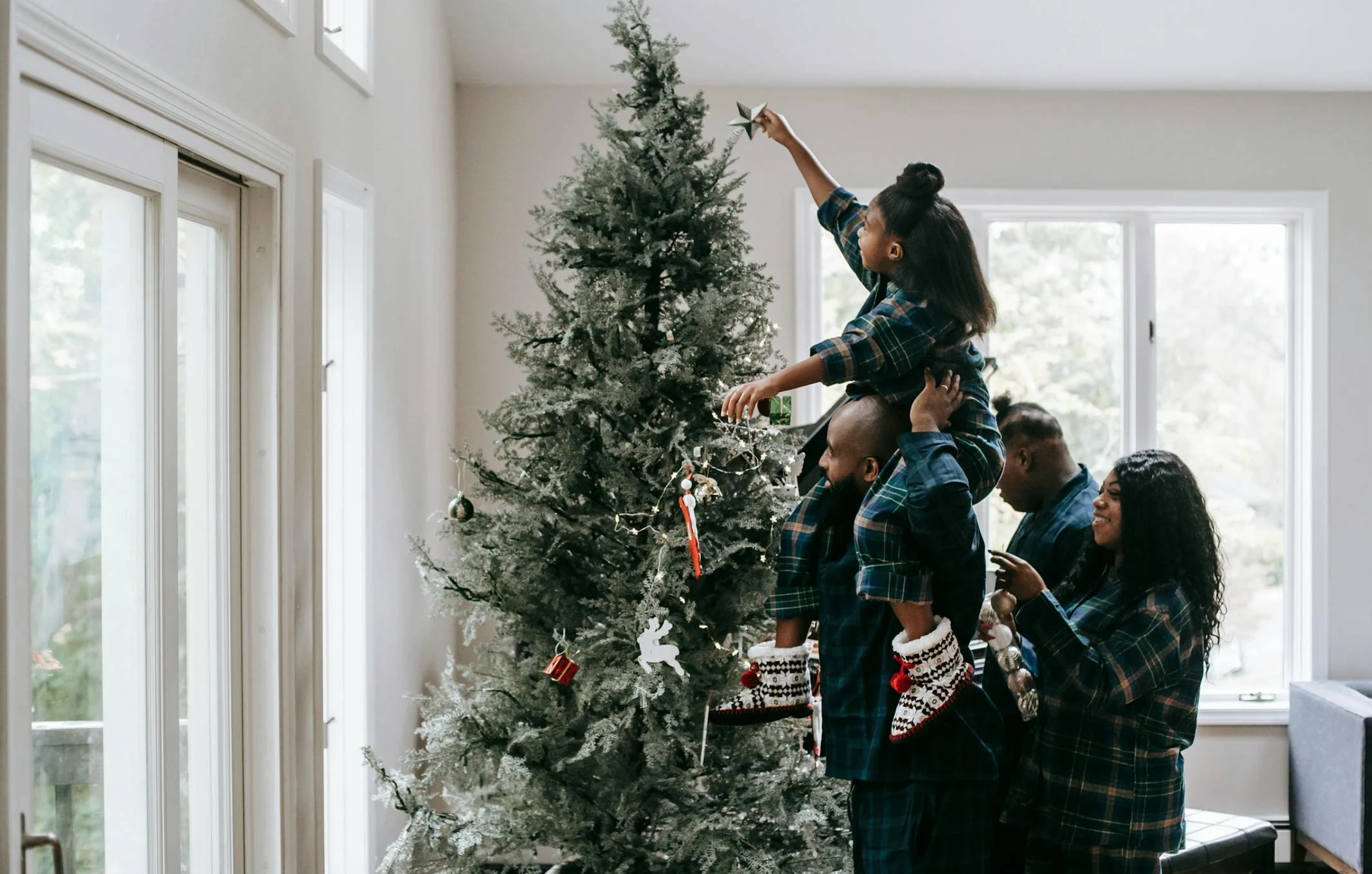 family decorating a christmas tree