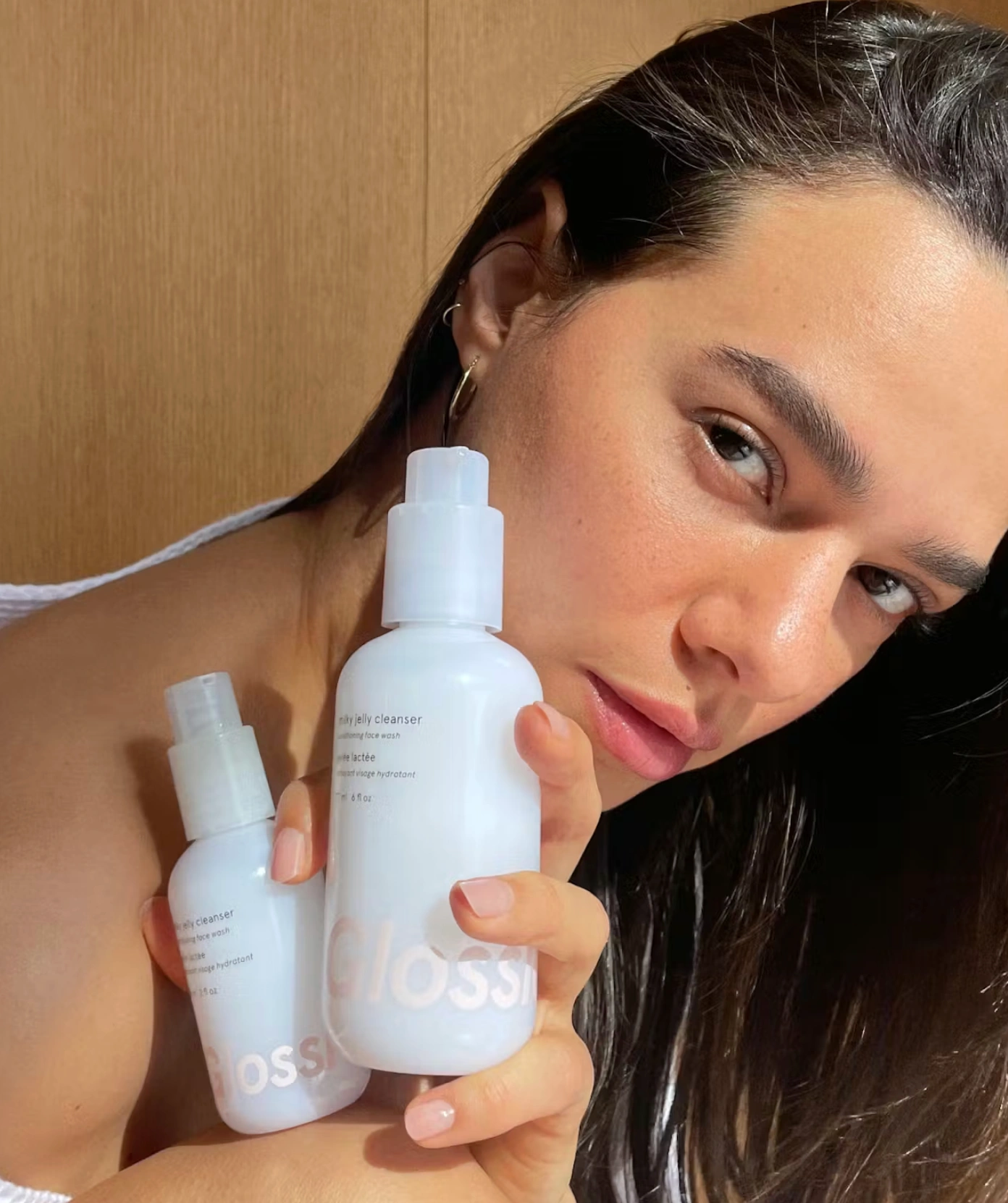 woman using Glossier staples