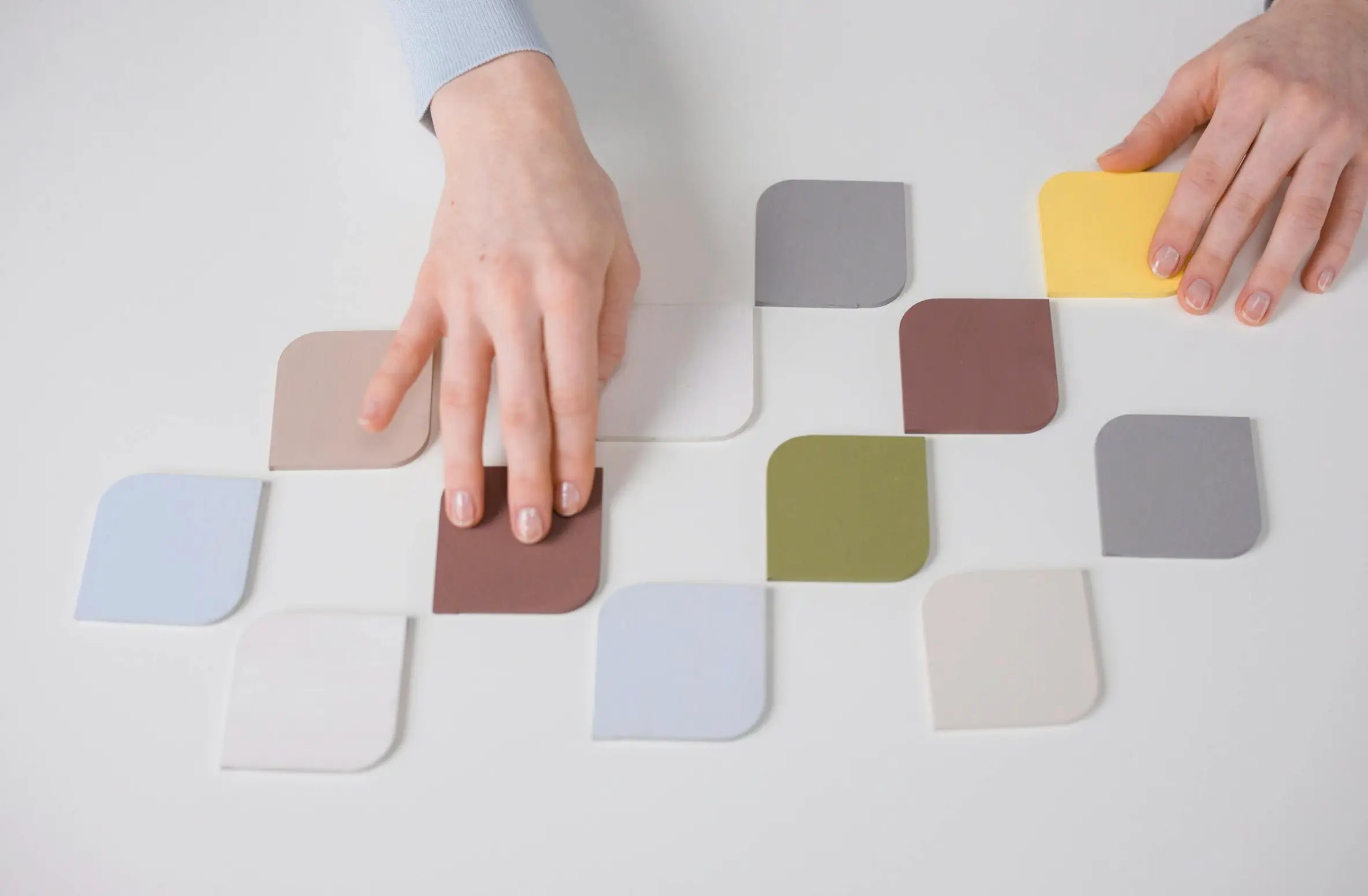 person touching color blocks