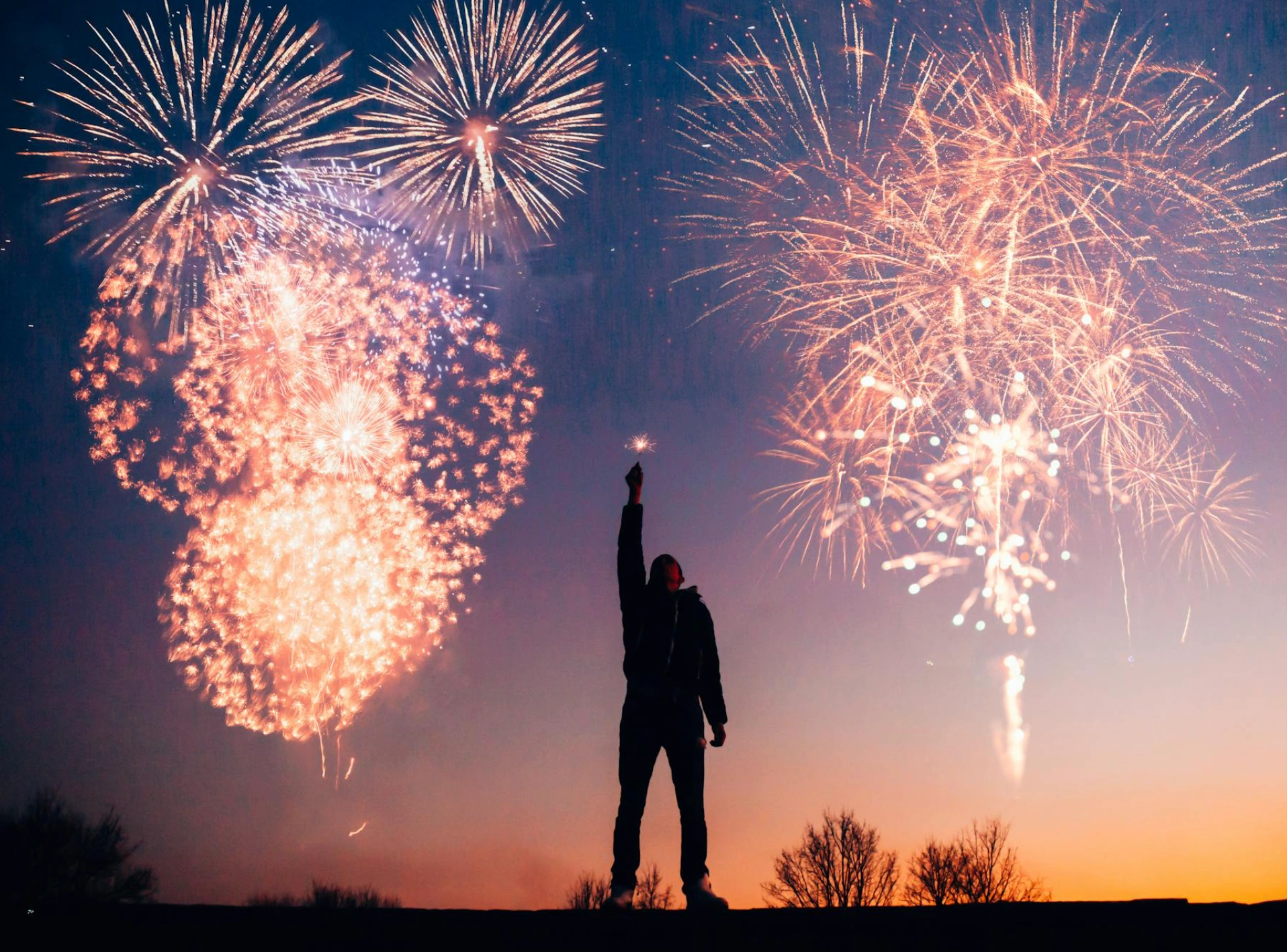 man in front of fireworks