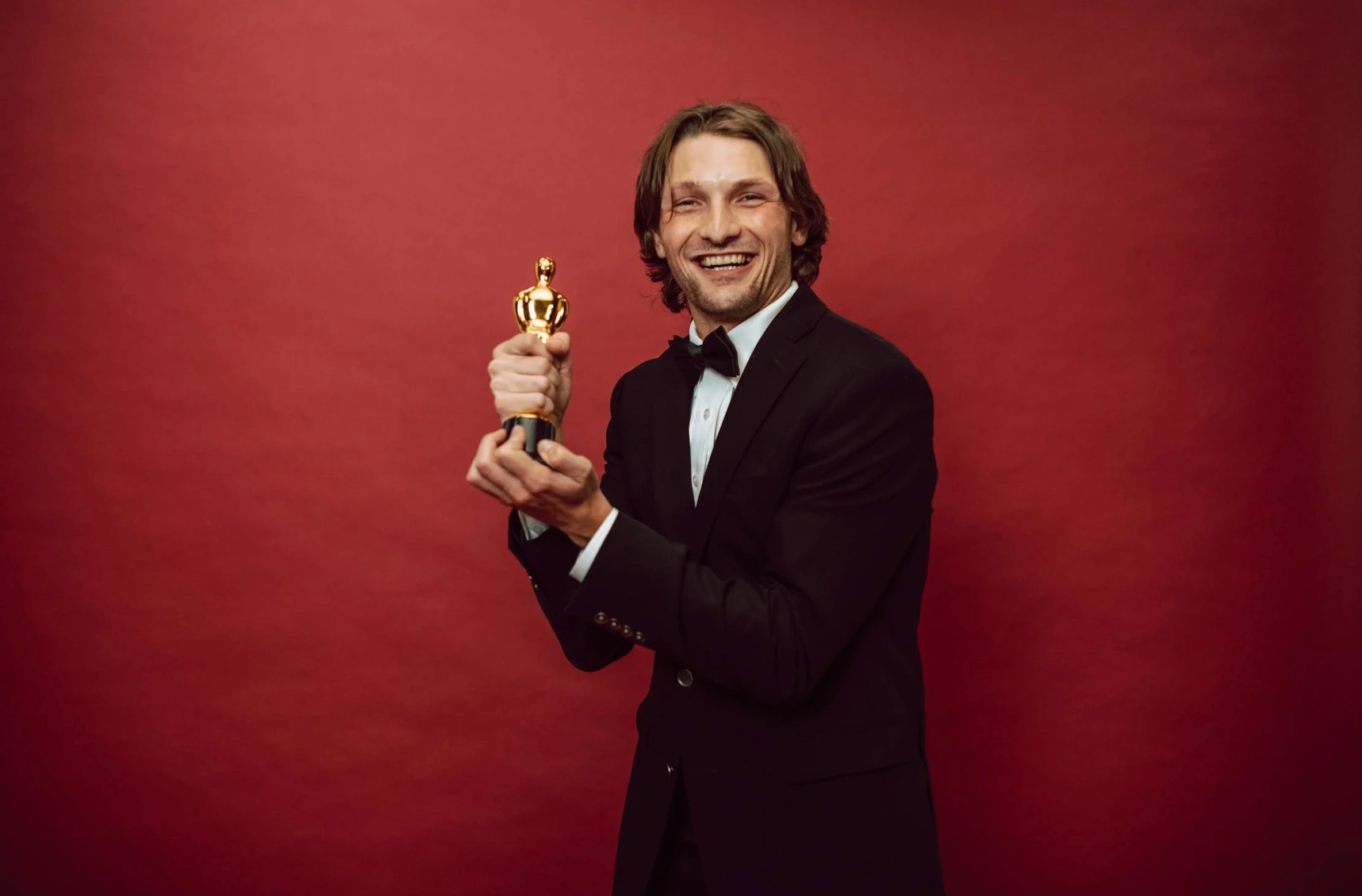 man holding an award in suit