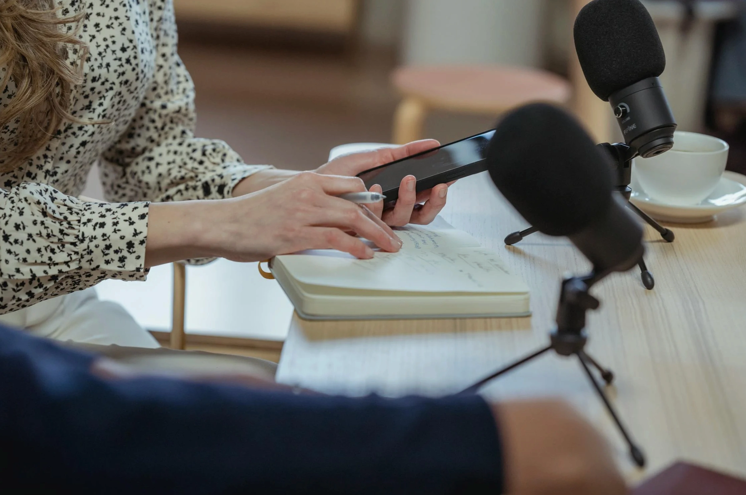 woman taking notes near microphone