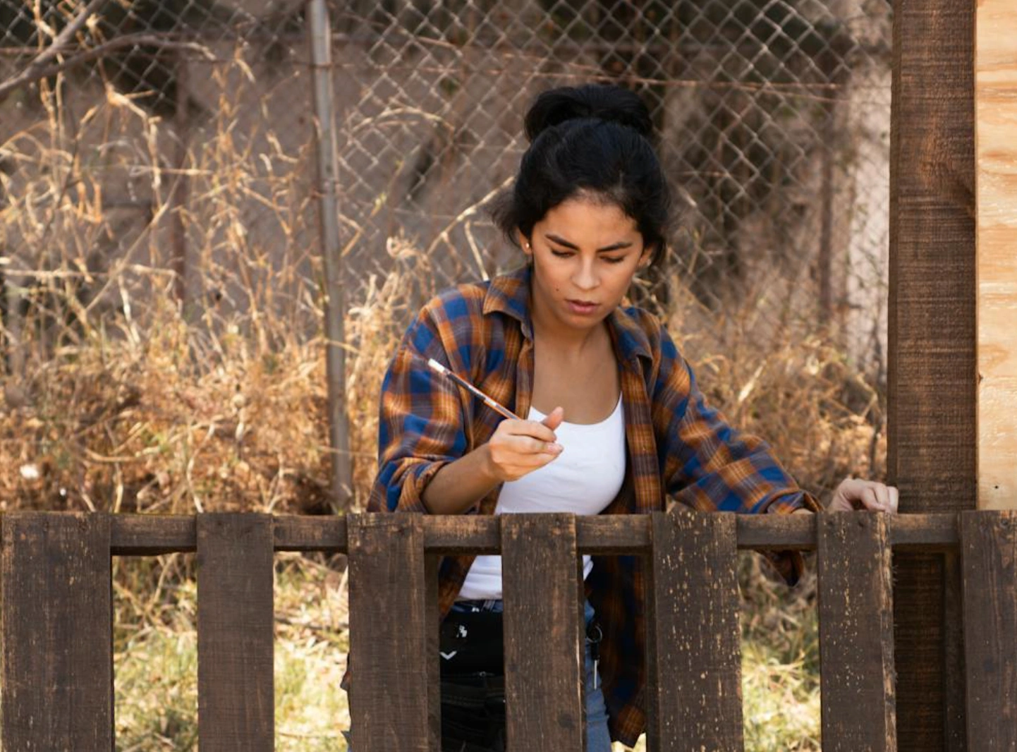 woman measuring fence