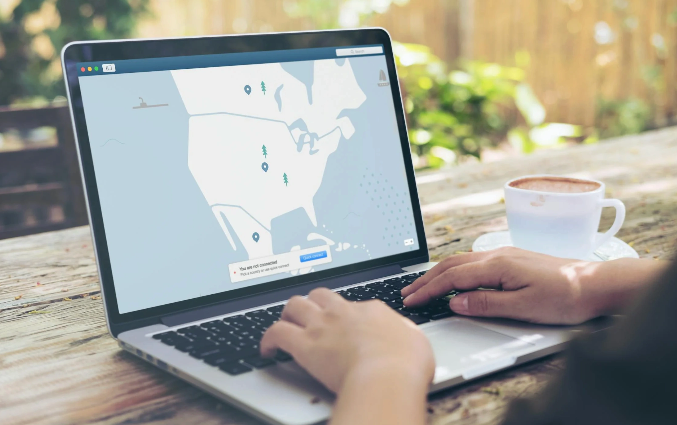 person typing at laptop with map on display