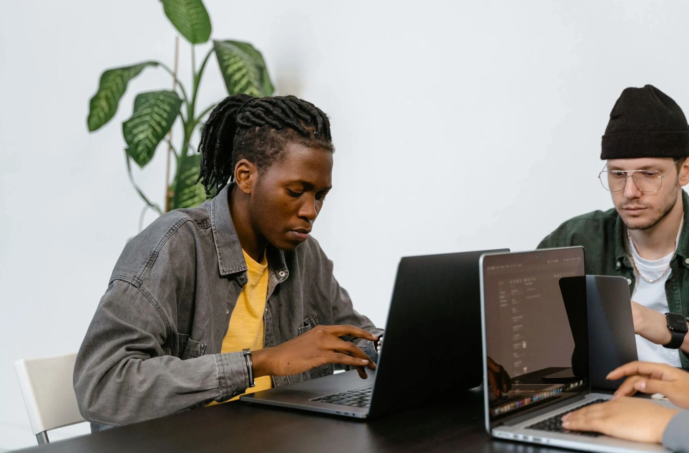 men working on laptop