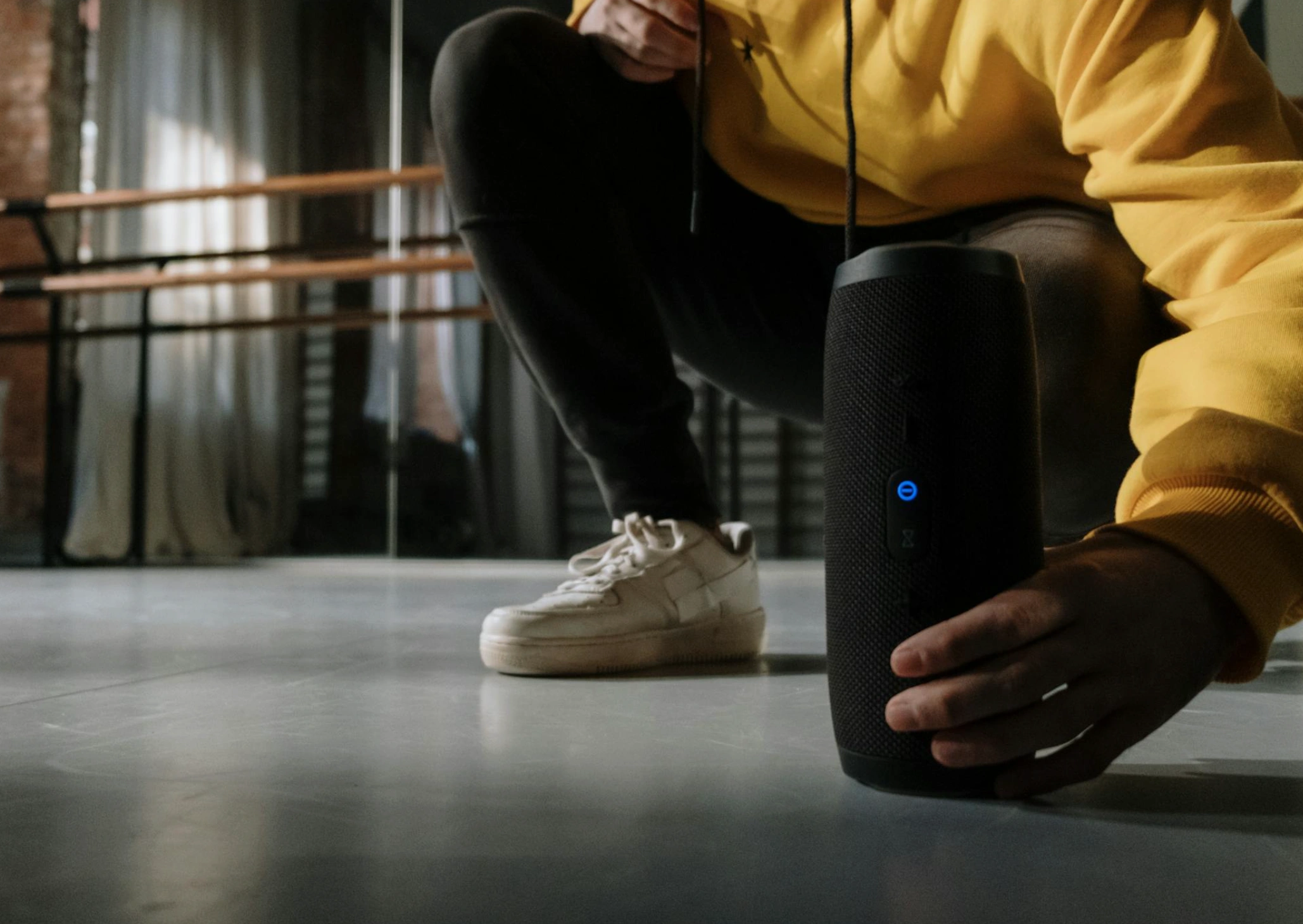 person placing speaker on the floor