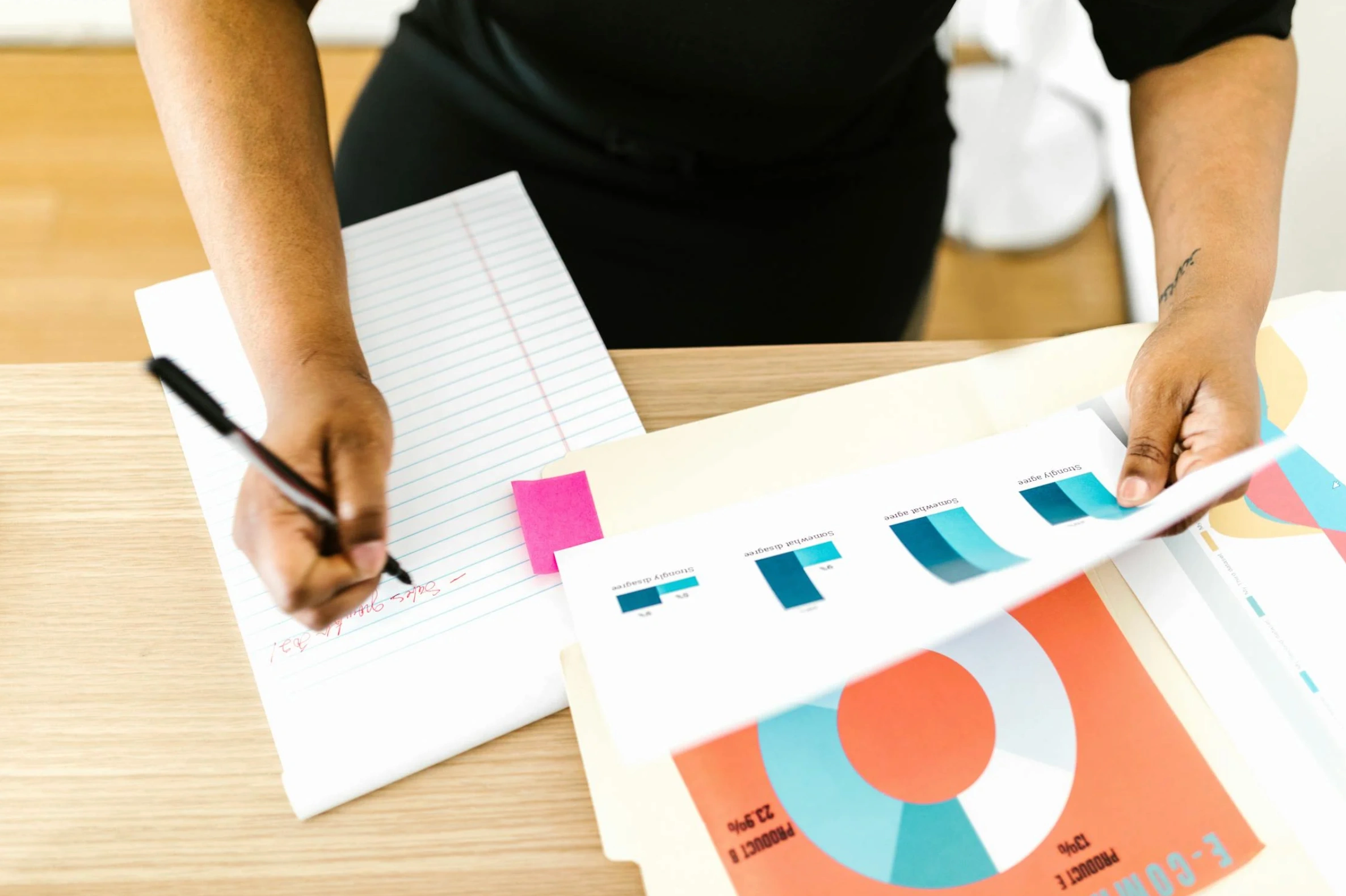 person writing notes on data