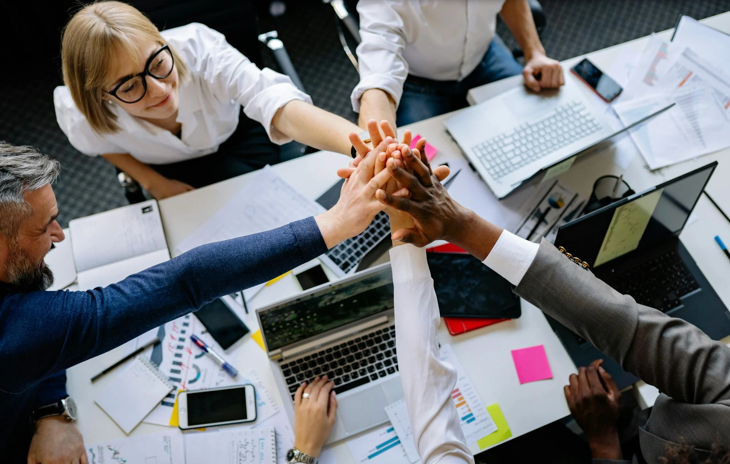 team doing a "hands-in" celebration
