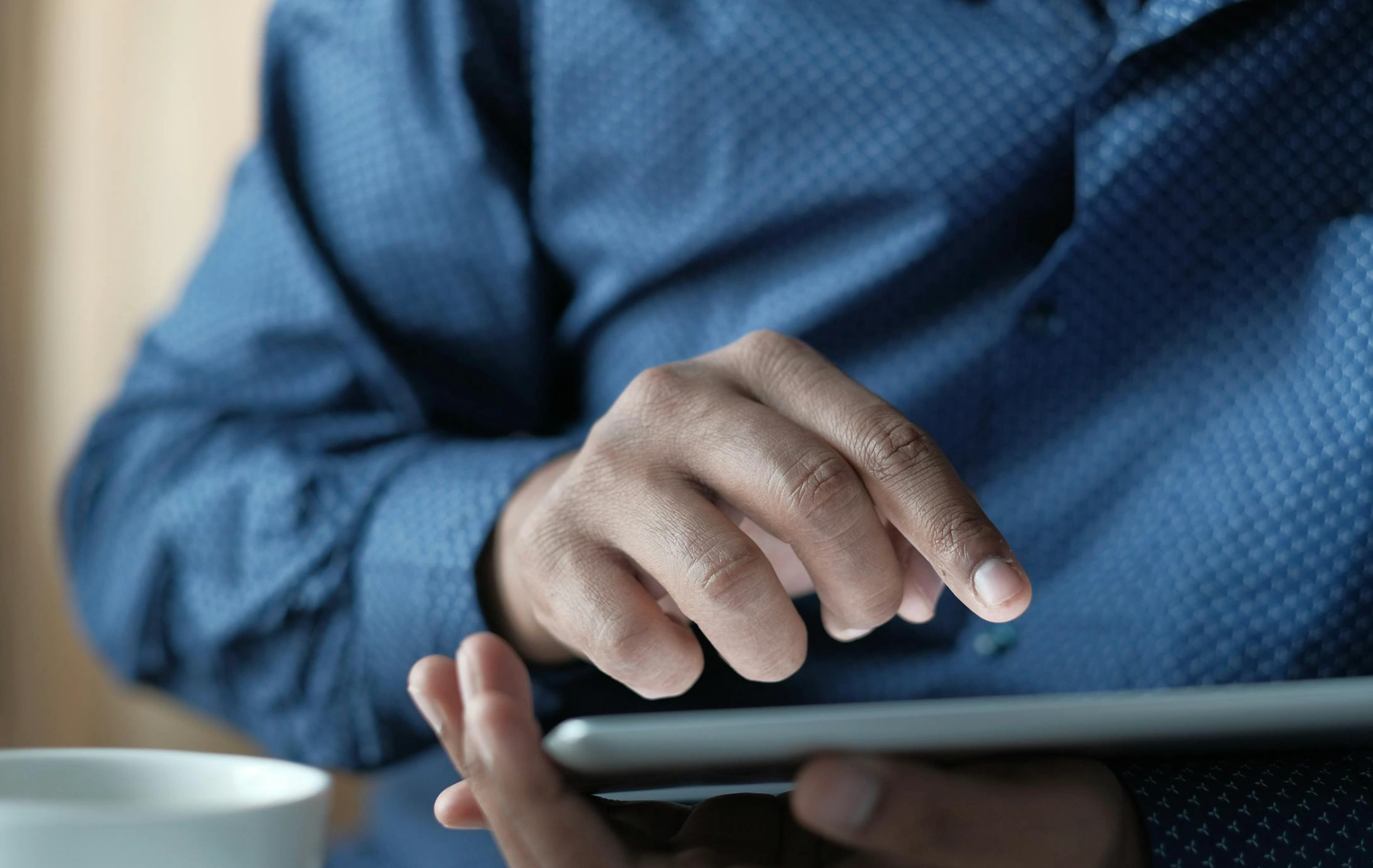 person tapping on tablet device