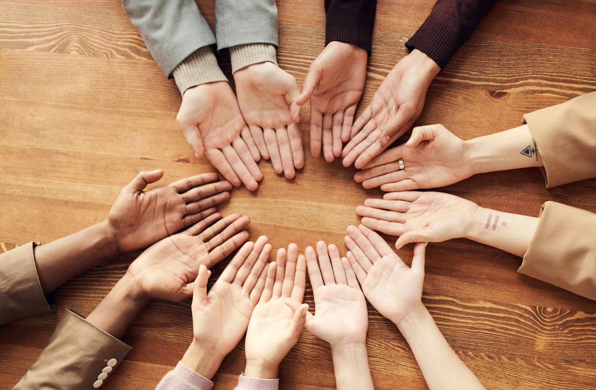 group of open hands linked together 