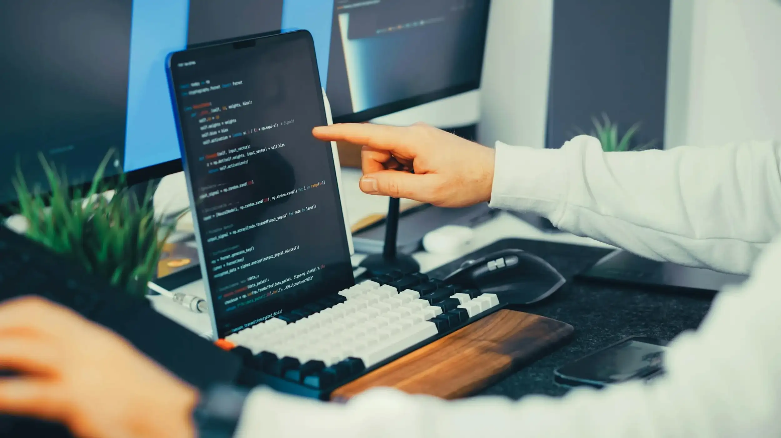 person pointing at laptop