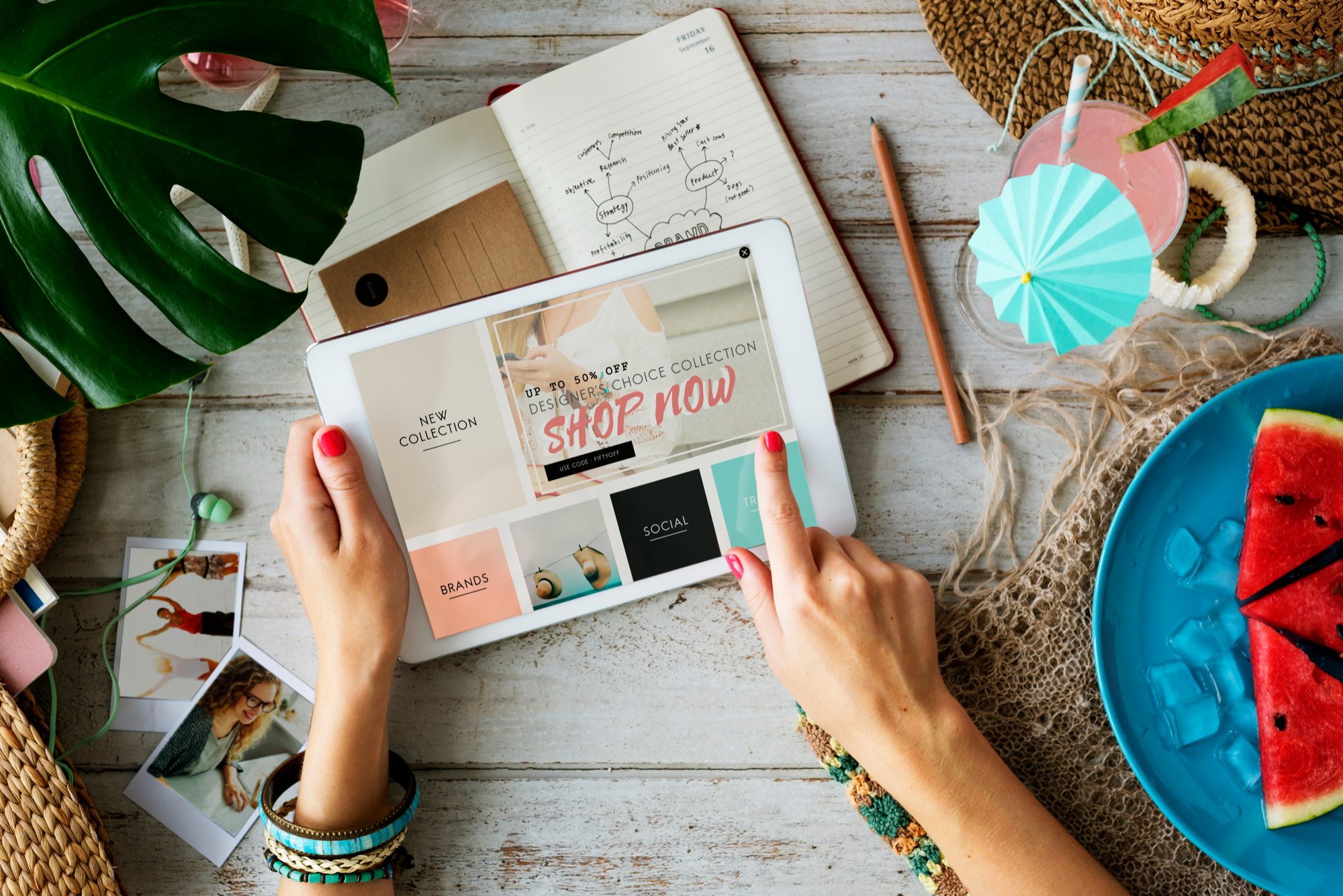 Person browsing an online shop on a tablet, planning notes and visuals for a content strategy for local SEO.