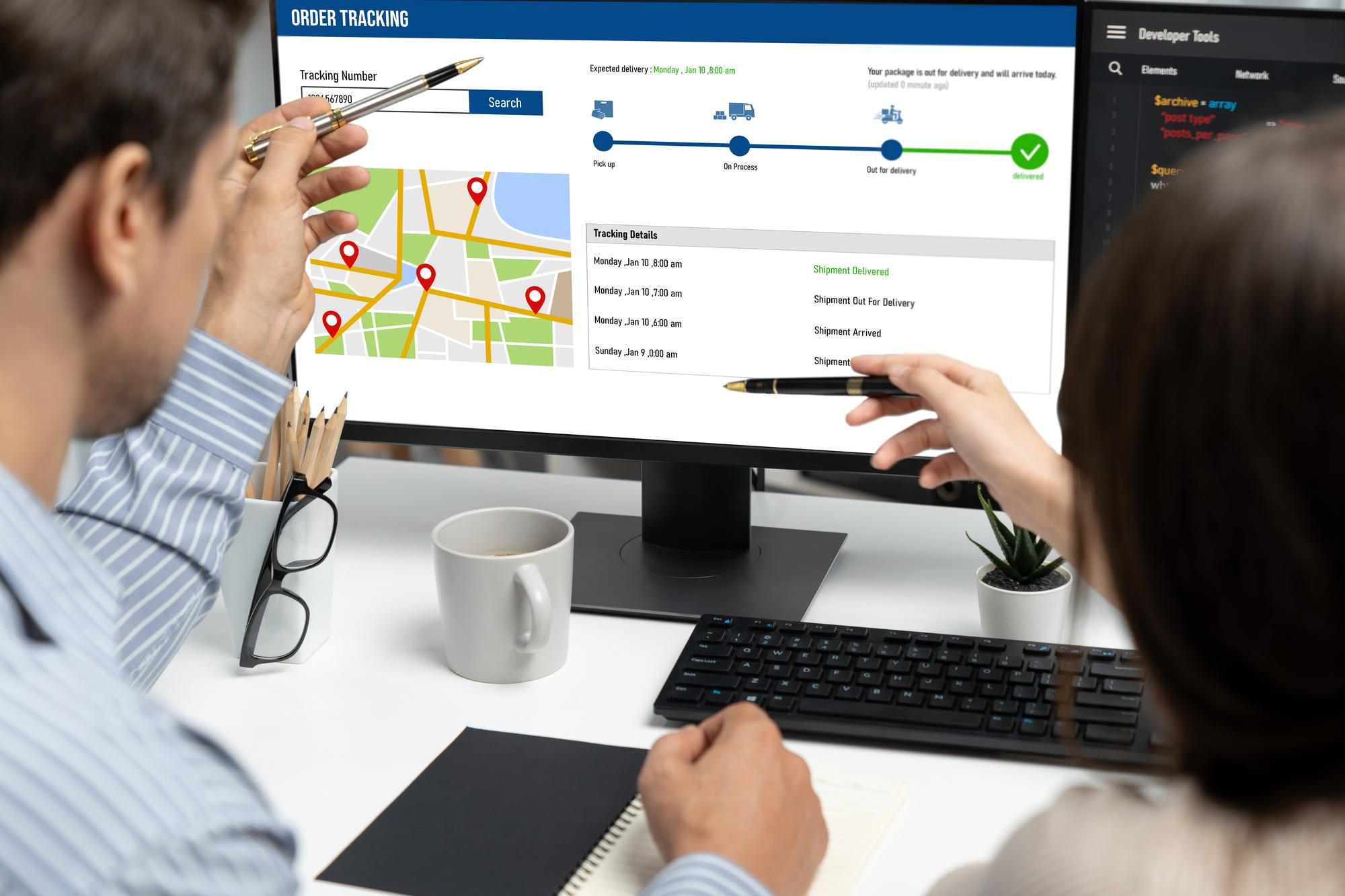 Two people are analyzing a screen with regional map data as part of an SEO strategy for multiple locations.