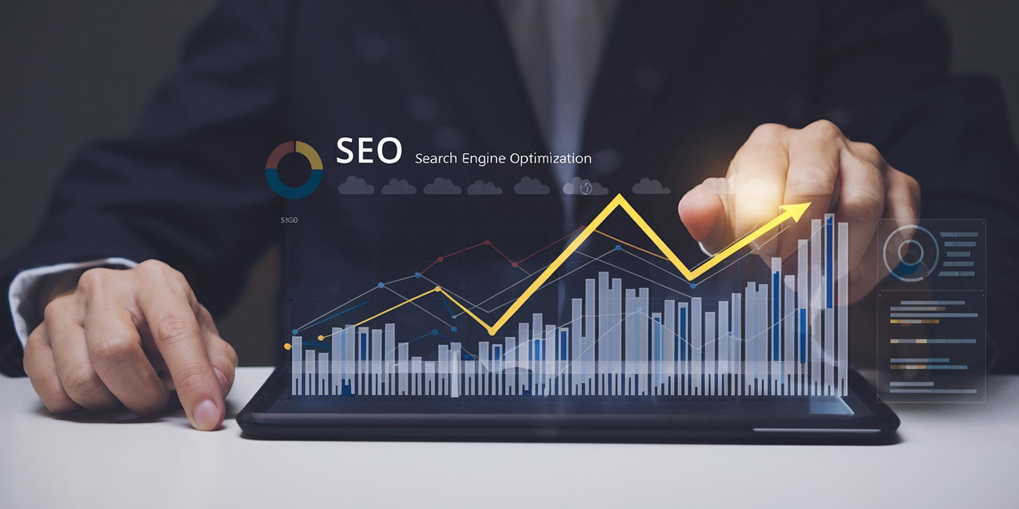 Businessman pointing at a rising bar chart on a tablet screen with an SEO label, representing growth from an SEO investment in Canada.
