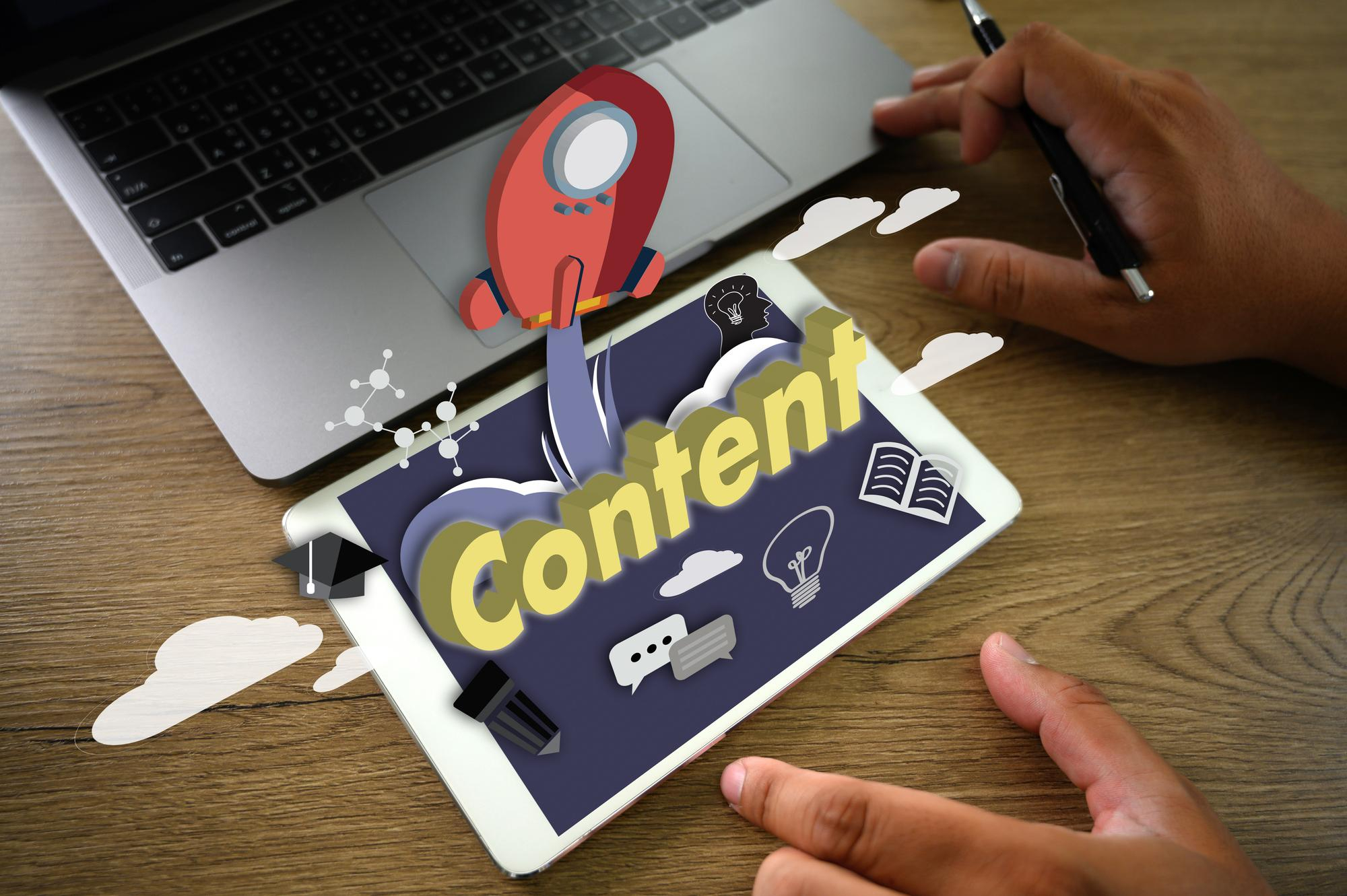 Hands working on a tablet displaying a content strategy graphic with a rocket launch illustration representing on-page SEO content creation and formatting.