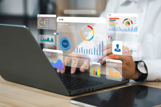 Analyst reviewing floating data dashboard with bar charts, pie charts and KPI metrics on laptop screen.