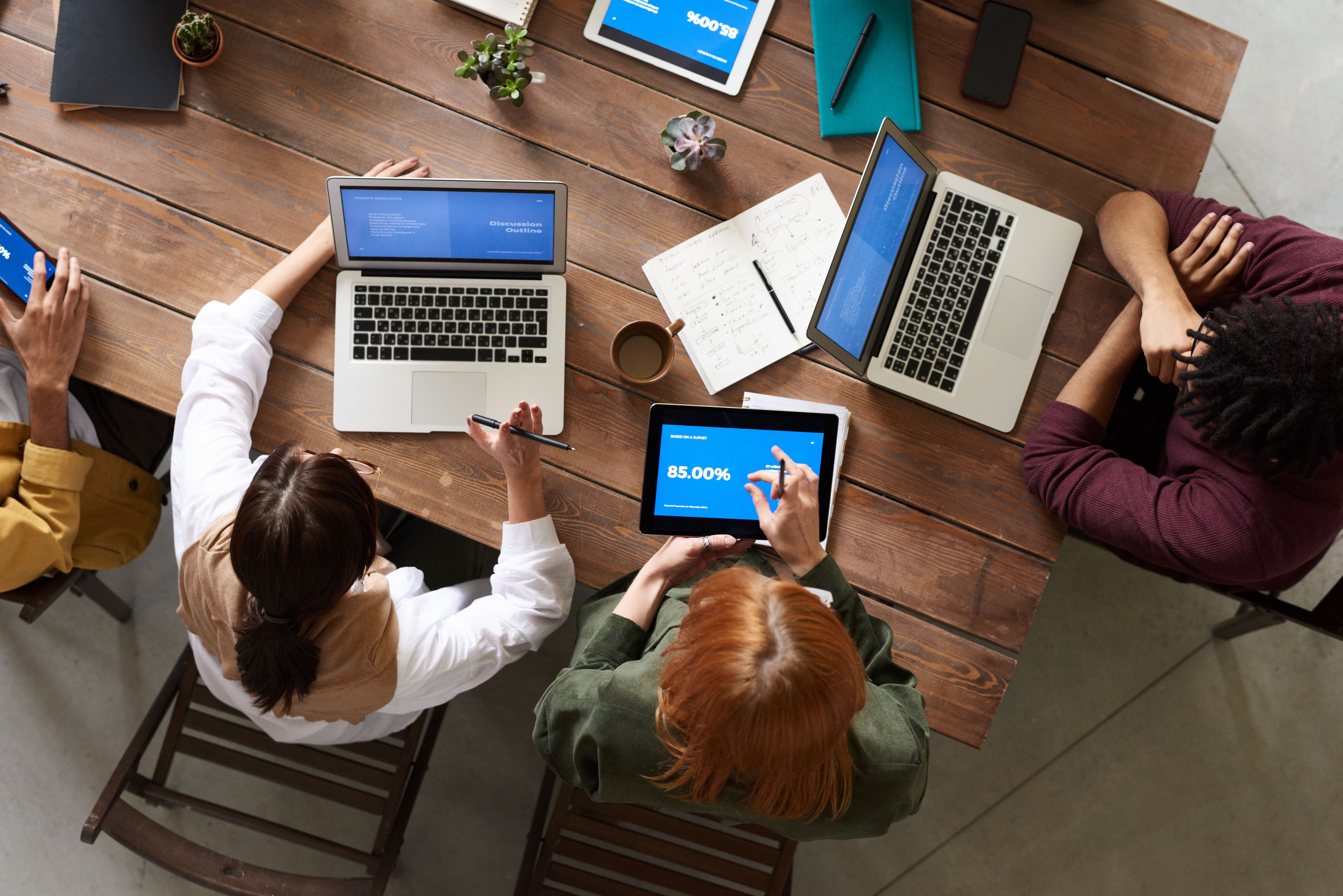 Marketing team reviews conversion data on tablet during strategy session
