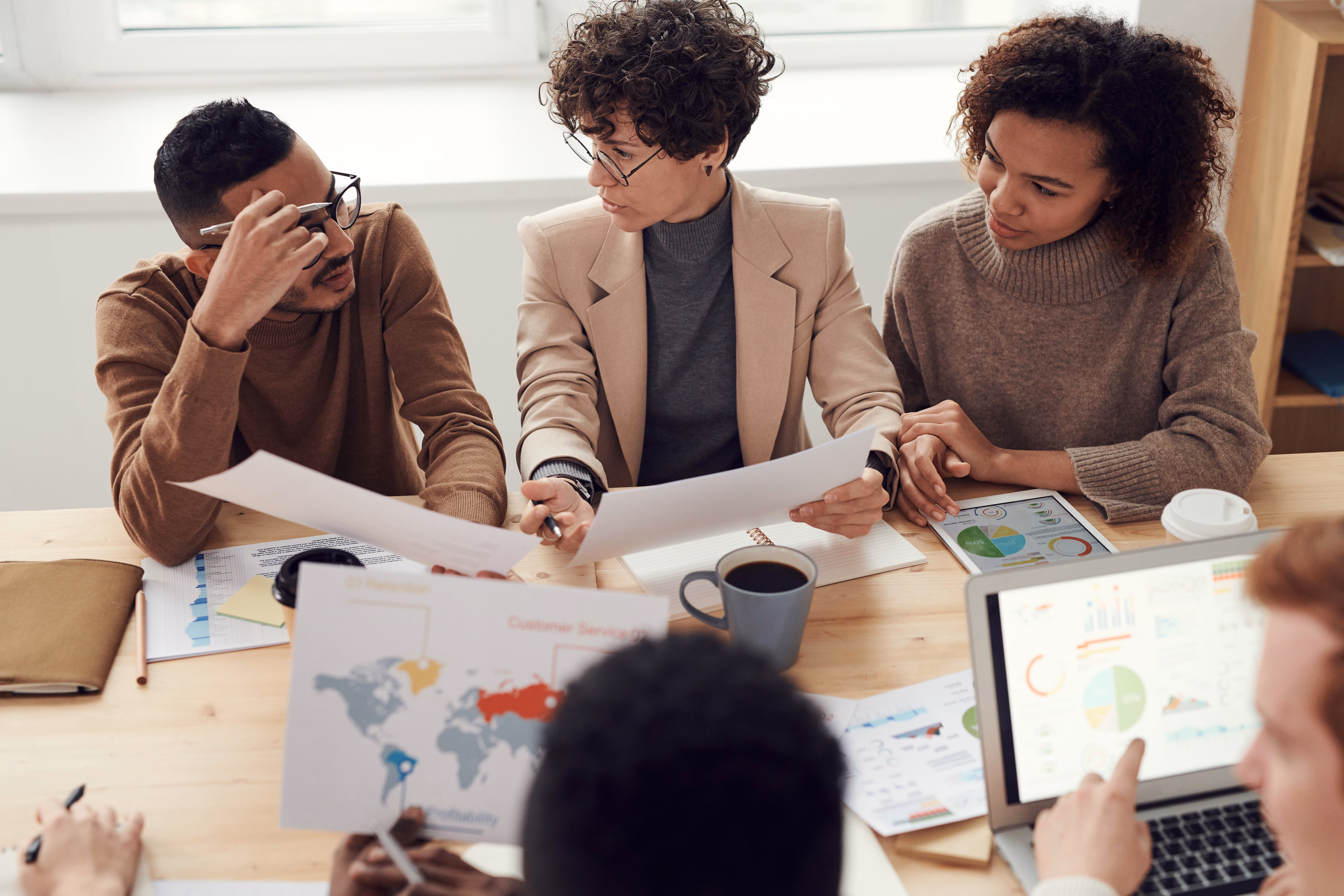 Marketing analytics team discusses global performance charts and profitability data