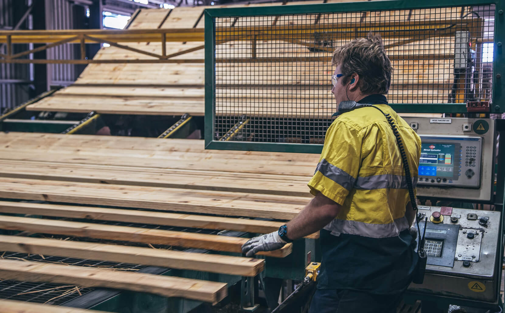 Hyne staff manually turning timber sticks