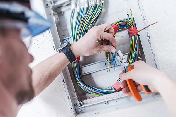 Man cutting electrical wires
