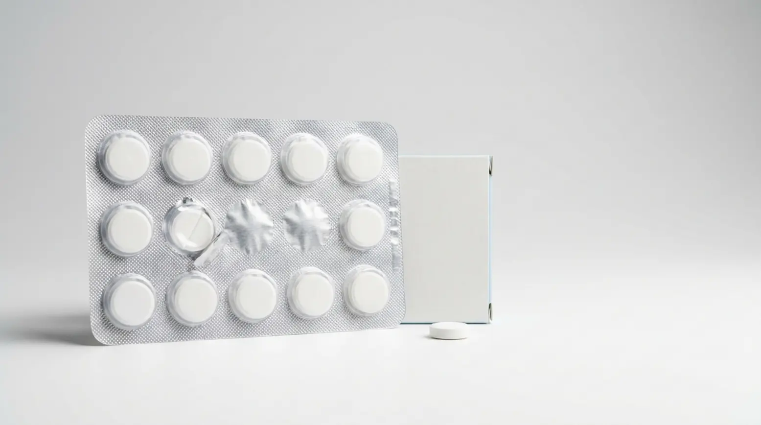 Pristine pharmaceutical blister pack with white tablets, minimalist design, soft lighting, clean backdrop.