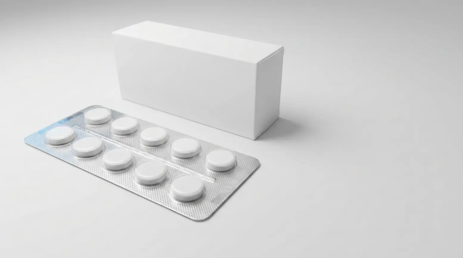 Ultra-wide photo of a pristine blister pack with white tablets, set on a clean matte surface.