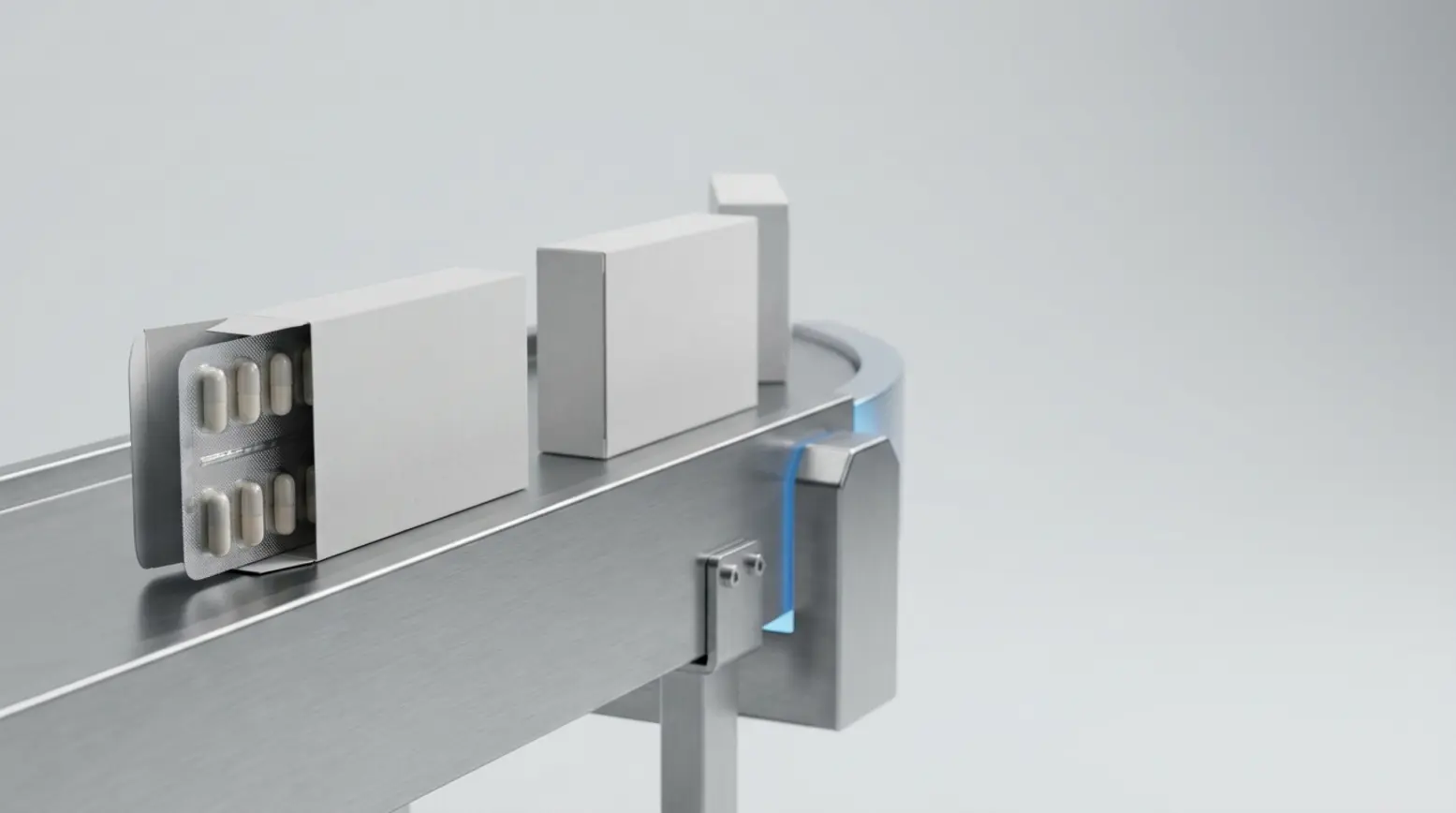 A clean composition of matte-white cartons on a conveyor, displaying an open blister pack with tablets.