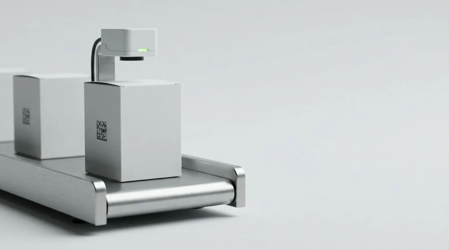 A sleek pharmaceutical carton on a stainless-steel conveyor, with a verification camera above it.