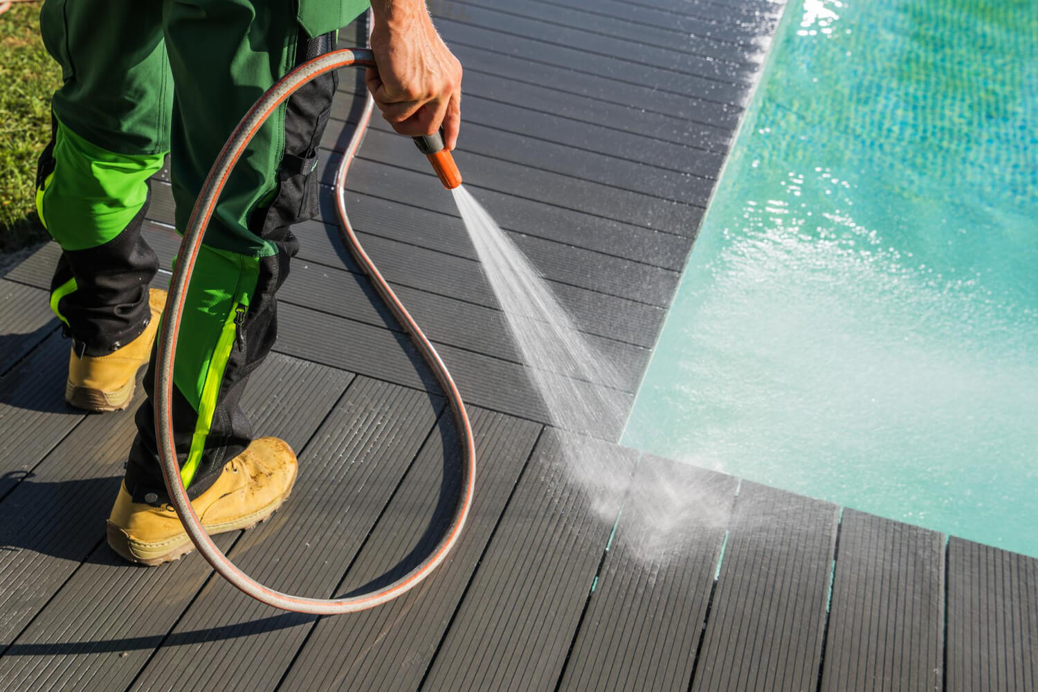 pressure washing around a pool deck