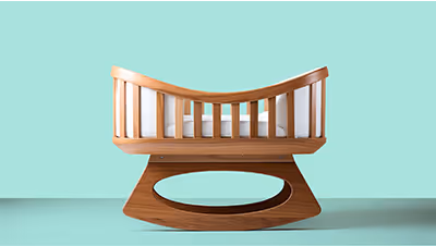 Cuna de madera sobre fondo celeste, representando cobertura médica materna desde el embarazo.