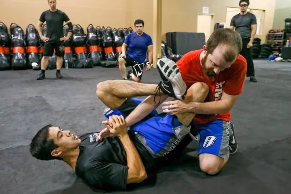 male kicks attacker from ground position