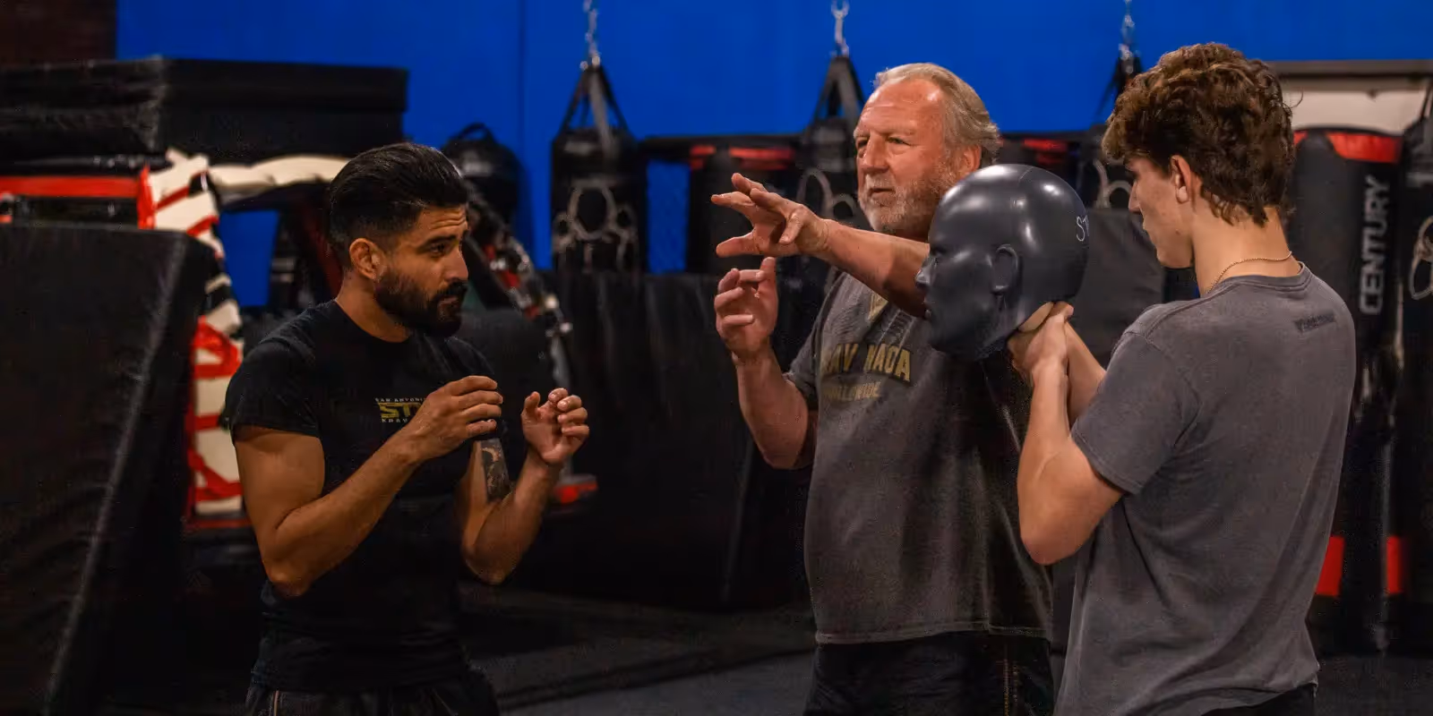 STW owner Pete Hardy works with two male students