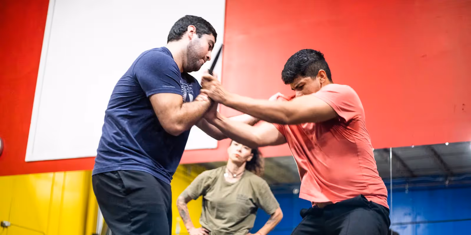male student doing knife defense