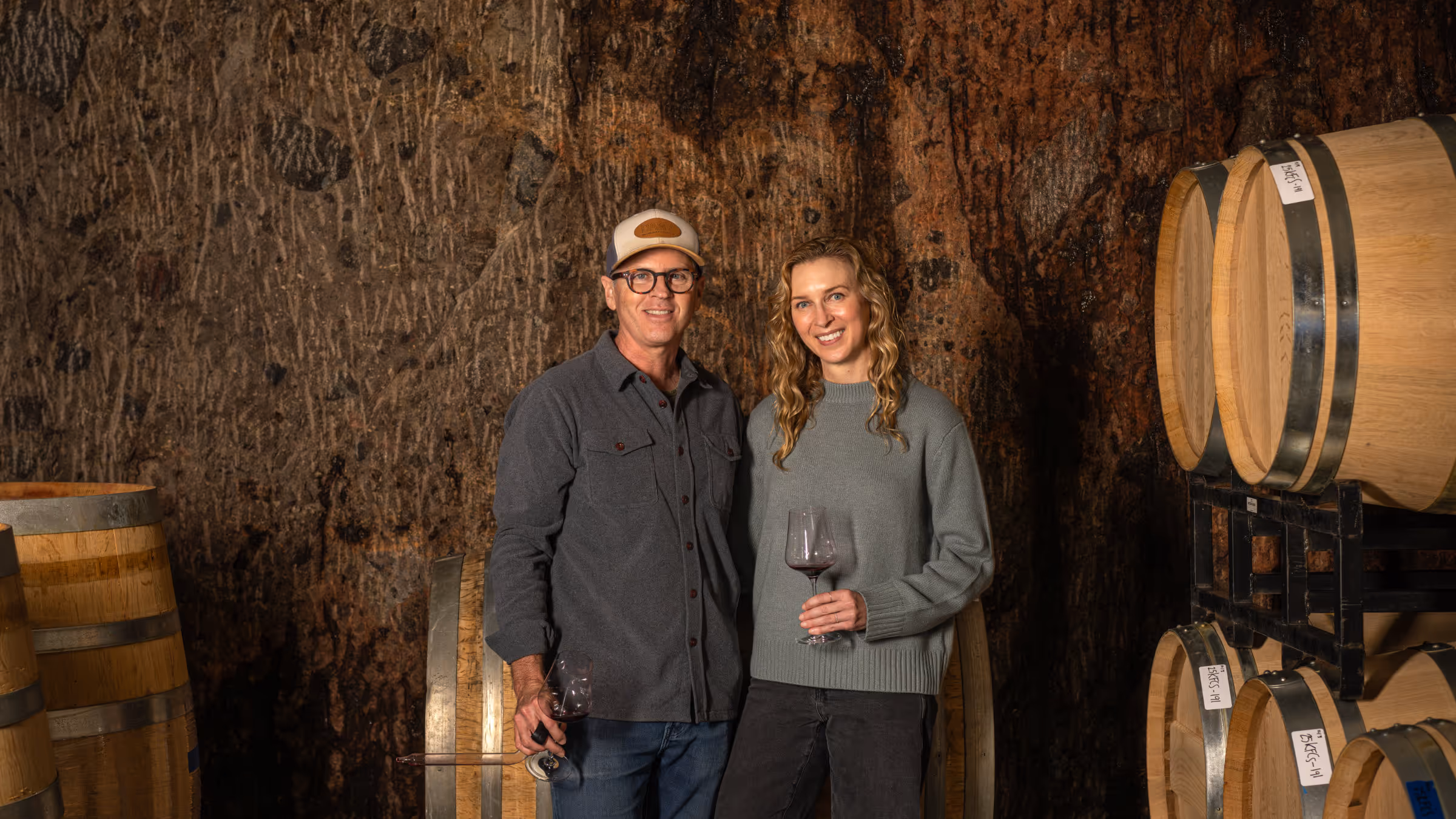 Mike and Schatzi in front of a Husic vineyard row at golden hour.