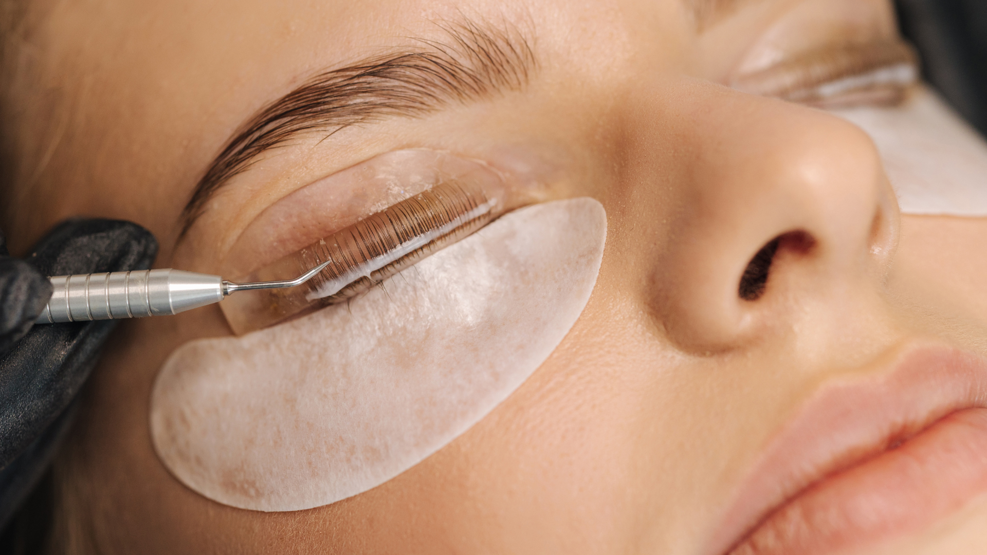 A woman undergoing lash lift treatment. 