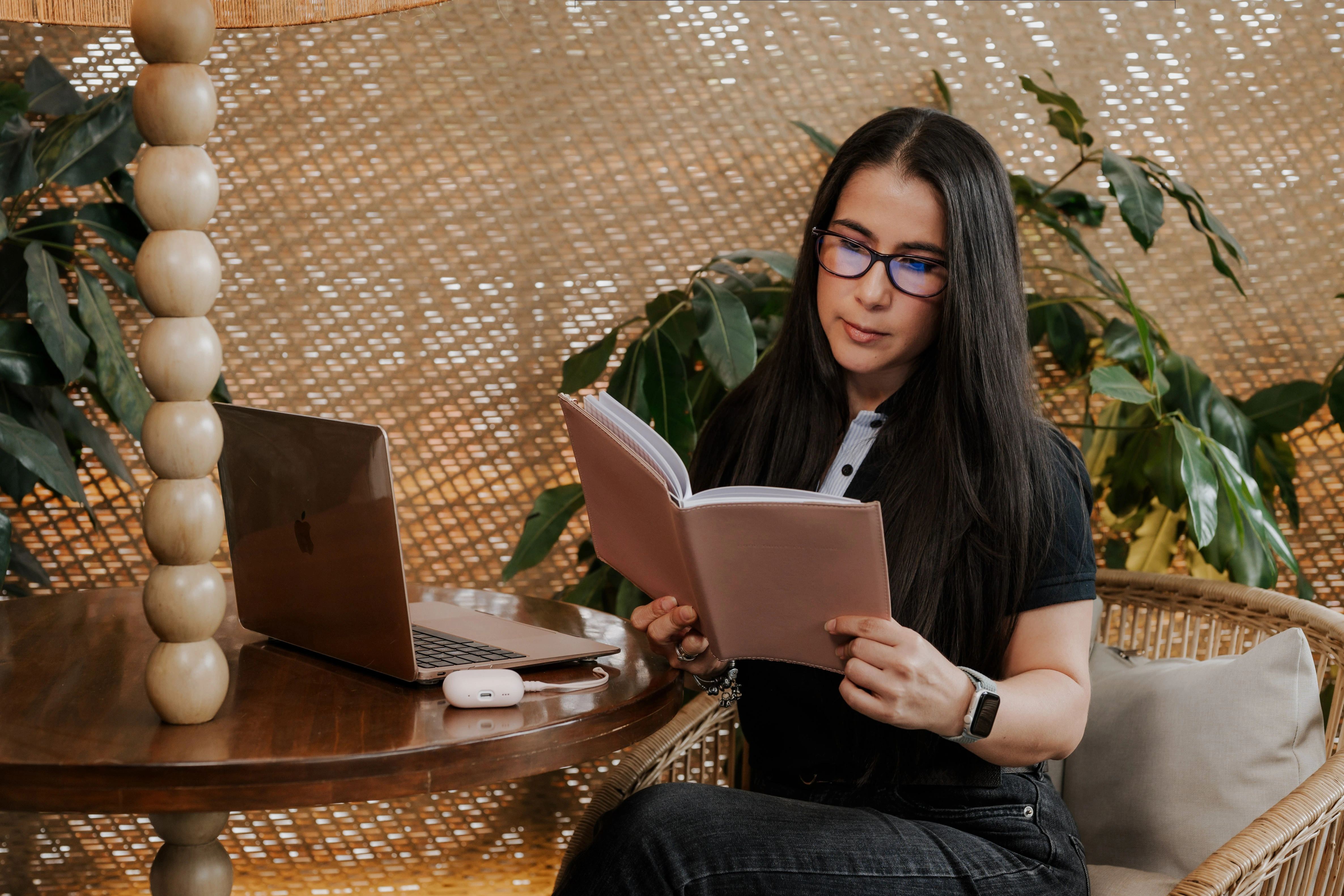A BetterWay Devs team member reviewing notes alongside her laptop